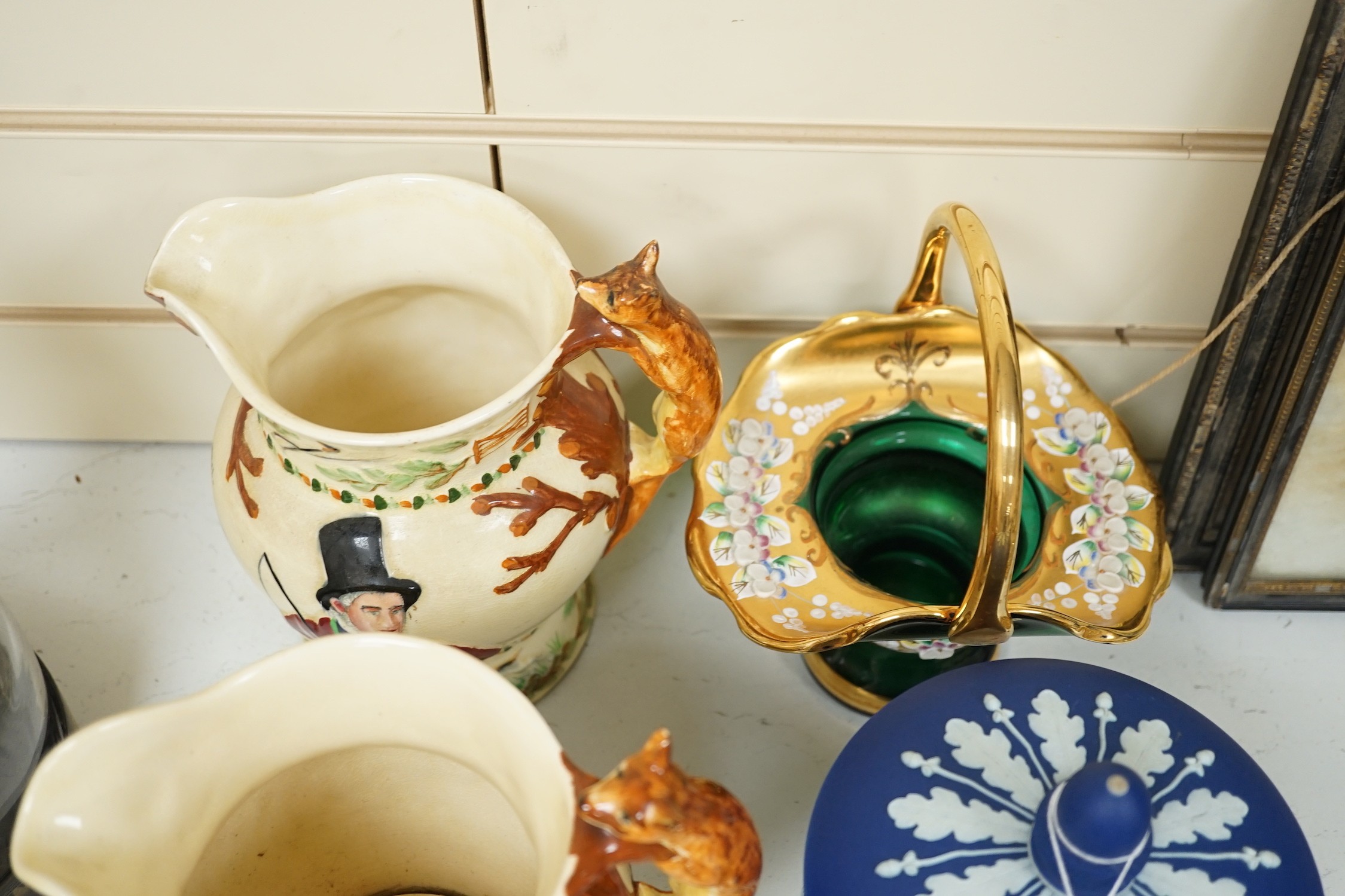 A pair of John Peel musical character jugs, a Wedgwood Jasper Ware biscuit box, enamel green glass basket and a pair of basket figural ceramic plates.